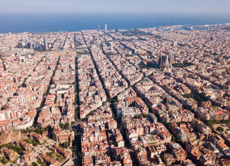 Aerial view of cityscape of Barcelona, Eixample district and Mediterranean coastline