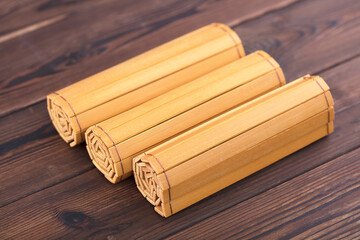 Three rolls of bamboo slips are on the table