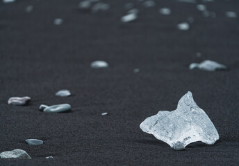 Ice diamond over the black sand of diamonds beach in Jokulsarlon