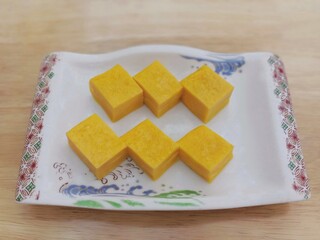 Japanese omelet style or dashimaki in dish on wooden texture background , Healthy food concept
