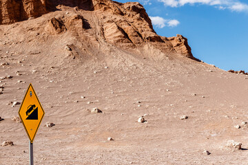 Yellow steep incline road sign for cars in the Moon Valley, Atacama desert, Chile, South America