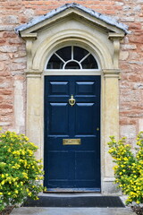 old wooden door of a beautiful house on a street in an english city
