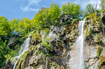 Fototapeta na wymiar Velky Slap Great Waterfall in Plitvice Lakes National Park, Croatia. Waters Flows Over a Vertical Steep Drop on a Sunny Day. UNESCO World Heritage.