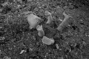 Abandoned doll in a pile of grey ashes. Violence against the Ukrainian people concept. War,...