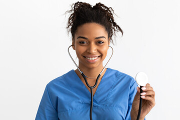 Portrait of black doctor smiling and showing stethoscope