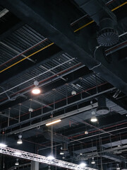Obraz premium Ceiling of a trade fair with pipes and safety system tools