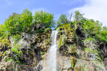 Rushing Water on the Greatest Waterfall of Plitvice Lakes National Park, Croatia, on a Sunny day with Bright Blue Sky. Waters Flow over Steep Rocks