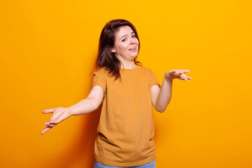 Portrait of caucasian woman being uncertain about question in studio. Unsure person not knowing and...