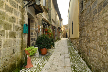 Fototapeta na wymiar A narrow street among the old stone houses of the oldest district of the city of Caserta Vecchia, Italy.