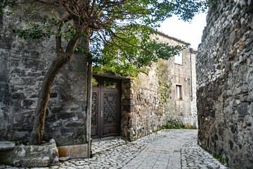 A narrow street among the old stone houses of the oldest district of the city of Caserta Vecchia, Italy.