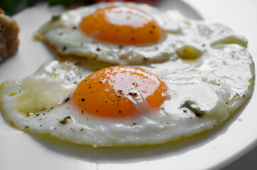 Fried eggs close-up, breakfast of eggs with vegetables