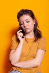 Modern person talking on phone call using smartphone on camera. Young woman holding mobile phone to talk to friends and family, using technology for remote communication. Adult chatting
