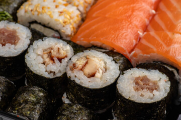 Japanese sushi food. Maki ands rolls with tuna, salmon, shrimp, crab and avocado. Top view of assorted sushi, all you can eat menu. Rainbow sushi roll, uramaki, hosomaki and nigiri