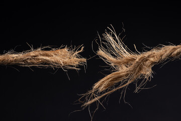 Breaking rope isolated on black background