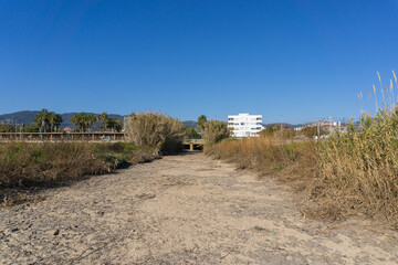 Dry river with hurdle around it on a beach in Premia de Mar - obrazy, fototapety, plakaty
