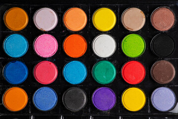 A set of colored paints in a box