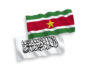National vector fabric wave flags of Taliban and Republic of Suriname isolated on white background. 1 to 2 proportion.