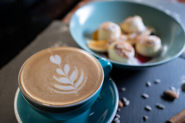 fresh coffee with cheese pancakes with banana, peanut butter and raspberry sauce