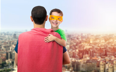 Happy loving father. Dad and his son playing outdoors. Dad and boy dressed as Superheroes. Father's...