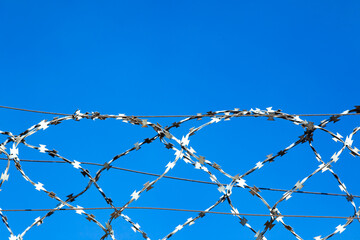 Barbed wire against the sky.