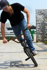 Leading up to a show-stopping trick. A BMX rider doing tricks out in the city.