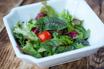 Salad of fresh vegetables with vegetable oil. Vegetarian dish. A dish from a chef in a restaurant.