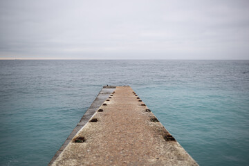 a pier that splits into two at the end and goes out to sea.