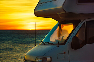 Caravan on beach at sunrise