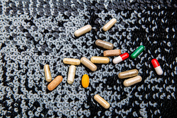 Pill on black sequin
