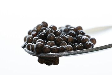 black caviar on a spoon. fresh sea food. 