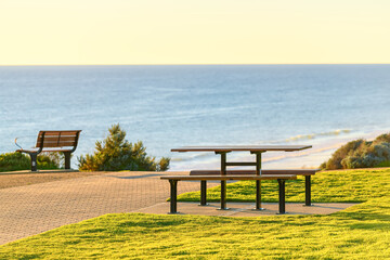 Picnic table at Maslin Beach sea shore at sunset, South Australia