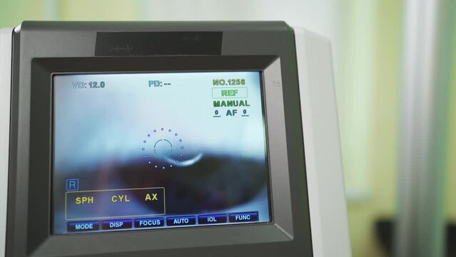 eye on the screen of the autorefractometer. a modern ophthalmic device.