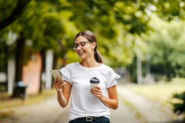 A college girl receiving an message on the phone at campus.