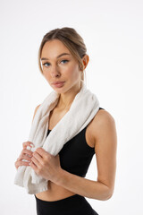 portrait of an attractive female in sportswear with a towel 