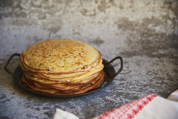 Delicious pancakes on a vintage metal platter on a concrete surface. Food background.