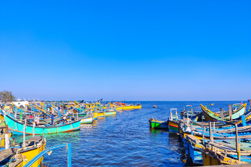 Fishing boats anchored near the shore. Blue sea landscape background.
