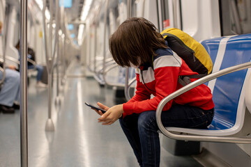 Children, traveling on the subway early in the morning, empty train, Barcelona