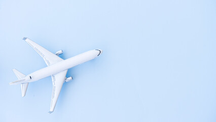 Naklejka na ściany i meble White airplane model on a blue background