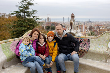 Family, children, posing in park Guell in Barcelona
