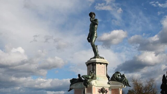 The Bronze sculpture of Michelangelo's David facing Florence against blue cloudy sky. Florence, Michelangelo Square. Timelapse.