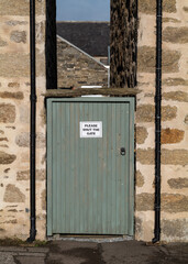 4 February 2022. Keith, Moray, Scotland. This is a door to a lane in Keith with the words - Please Shut ( Close ) the Gate.