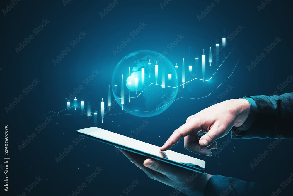 Poster close up of businessman hand pointing at tablet with glowing blue business chart hologram with globe