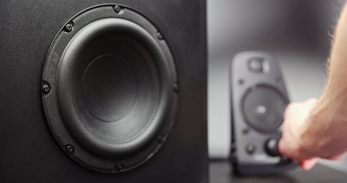 Turning on speakers with subwoofer moving closeup