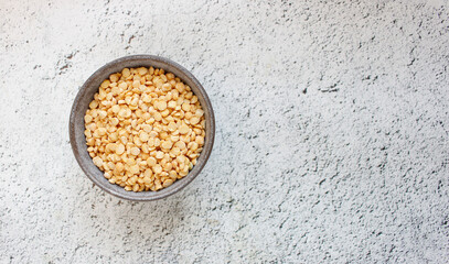 Pea groats on background. with copy space for your text, top view.