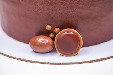 Whole homemade honey cake garnished and strawberry slices