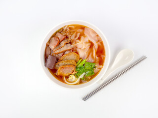 Top view of Yen Ta Fo or Thai spicy pink noodle soup isolated on white background
