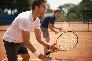 Their friends and great rivals on the court. Two male tennis players on the court.