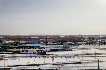 Fototapeta na wymiar freight train cars on the railway track top view and view of the city and rails