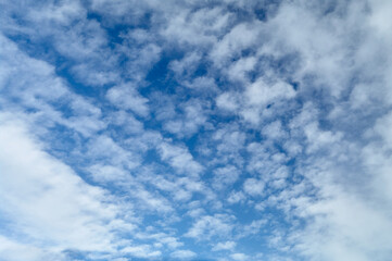 Winter blue sky on which cumulus and cirrus clouds float, natural abstraction, sky landscape