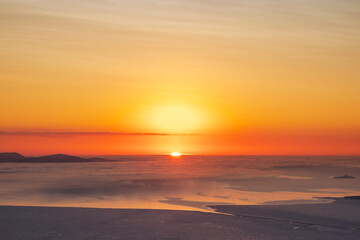 Beginning of sunrise. Colorful sky background concept. Dramatic sunset with twilight colors. Beautiful Arctic sunset. Scenic colorful sky at dawn. Aerial view.